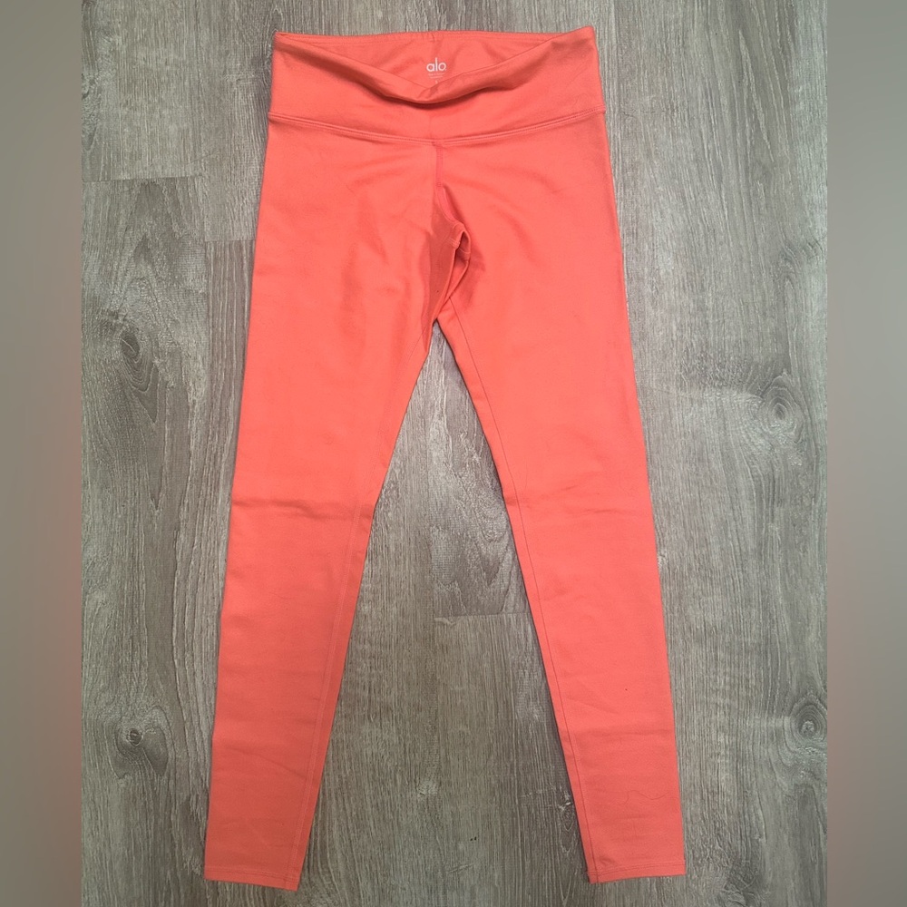 Alo Yoga coral colored leggings in size small.